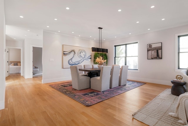 dining area featuring a wealth of natural light, light wood-type flooring, and crown molding