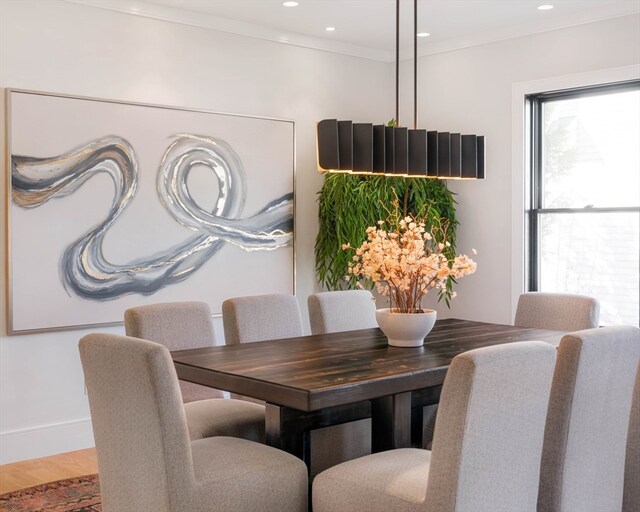 dining room with ornamental molding and hardwood / wood-style floors