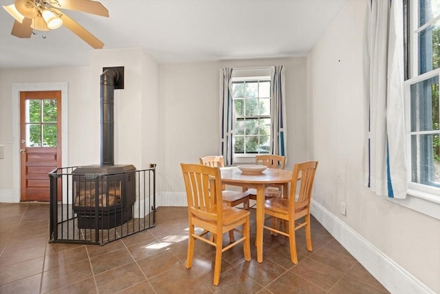 21 College Hill Rd, Somerville, MA 02144 - tiled dining area with a wood stove, plenty of natural light, and baseboards