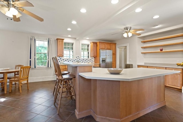 21 College Hill Rd, Somerville, MA 02144 - kitchen with stainless steel fridge, a ceiling fan, a kitchen island, recessed lighting, and light countertops