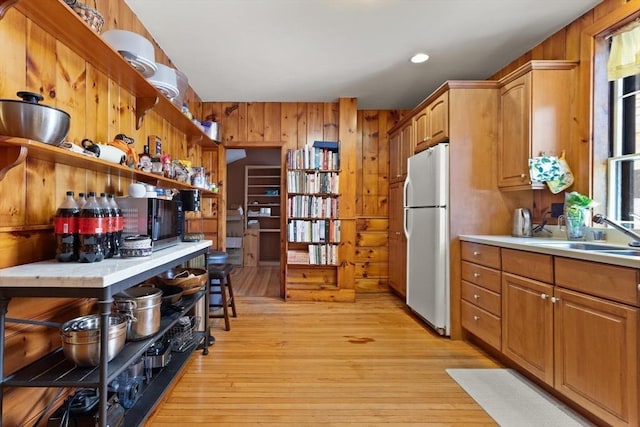 21 College Hill Rd, Somerville, MA 02144 - kitchen with freestanding refrigerator, a sink, open shelves, light countertops, and light wood finished floors