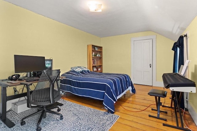 21 College Hill Rd, Somerville, MA 02144 - bedroom with wood-type flooring, vaulted ceiling, and a desk