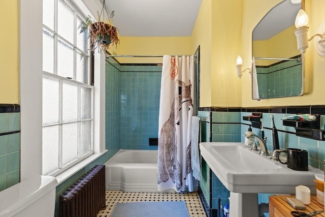 21 College Hill Rd, Somerville, MA 02144 - full bathroom featuring radiator heating unit, shower / bath combo with shower curtain, tile walls, a wainscoted wall, and tile patterned floors