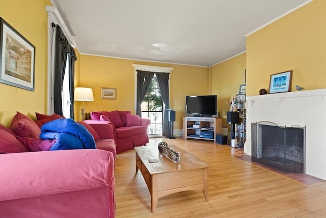 21 College Hill Rd, Somerville, MA 02144 - living area with light wood finished floors, ornamental molding, and a brick fireplace