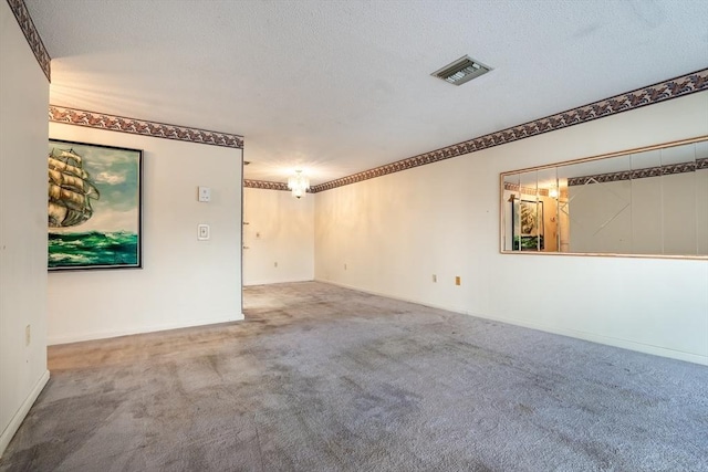 empty room featuring carpet and a textured ceiling