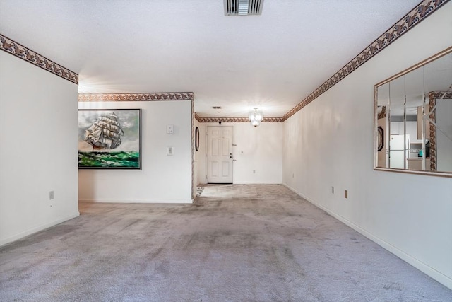 carpeted spare room featuring crown molding