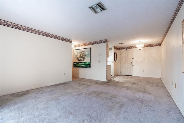 carpeted empty room featuring ornamental molding