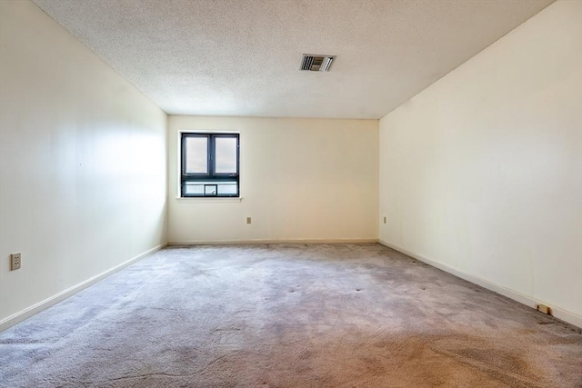 carpeted spare room featuring a textured ceiling