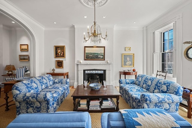 living area with a chandelier, crown molding, a premium fireplace, recessed lighting, and arched walkways
