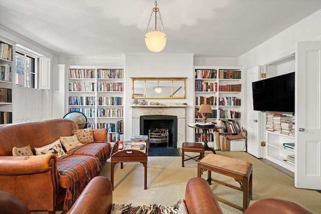 living room with carpet flooring, a premium fireplace, and built in shelves