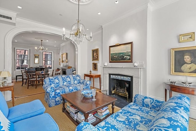 carpeted living area featuring a chandelier, arched walkways, ornamental molding, a high end fireplace, and recessed lighting