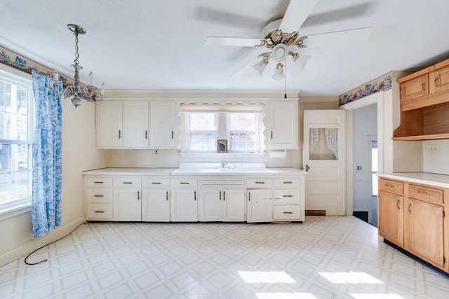 kitchen with light flooring, light countertops, a ceiling fan, open shelves, and white cabinets