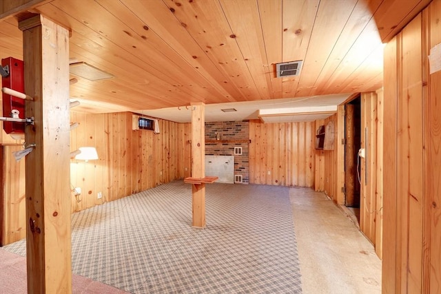 finished basement with wood walls, wood ceiling, and carpet flooring