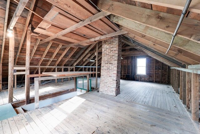 attic featuring an upstairs landing