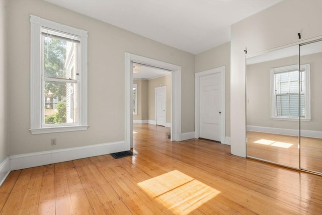 57 Rindge Ave, Cambridge, MA 02140 - unfurnished bedroom featuring baseboards, light wood-style floors, and a closet