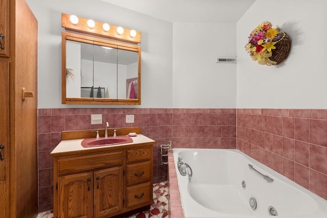 57 Rindge Ave, Cambridge, MA 02140 - full bathroom with a tub with jets, tile walls, vanity, and wainscoting