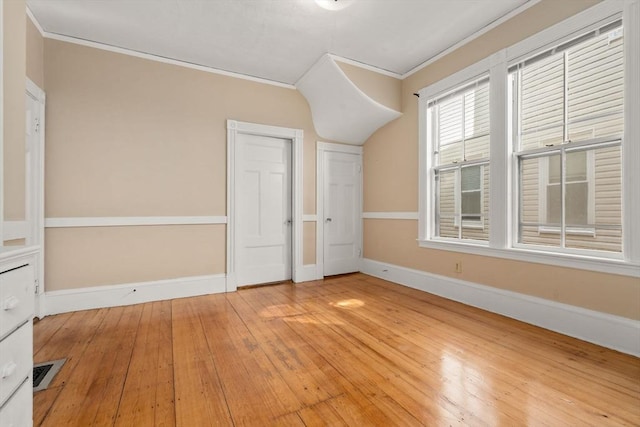 57 Rindge Ave, Cambridge, MA 02140 - unfurnished bedroom with ornamental molding, hardwood / wood-style flooring, and baseboards