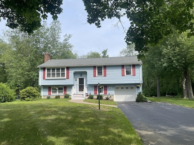 20 Colby Rd, Bridgewater, MA 02324 - bi-level home with asphalt driveway, a garage, a chimney, and a front lawn