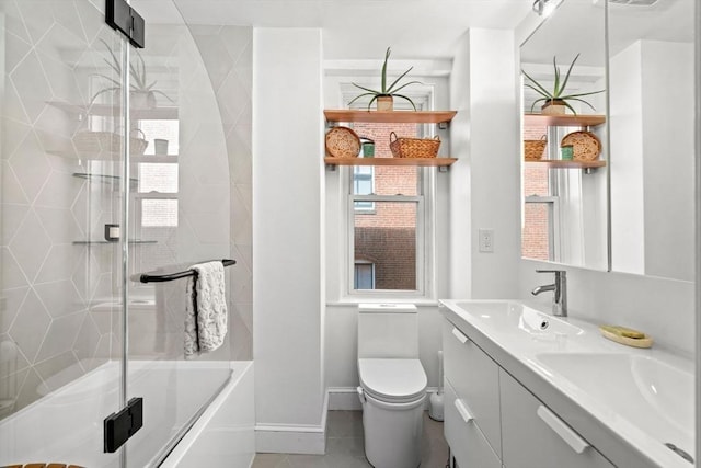 220-224 Washington St Unit 6, Brookline, MA 02445 - full bathroom featuring double vanity, a sink, baseboards, tile patterned floors, and toilet