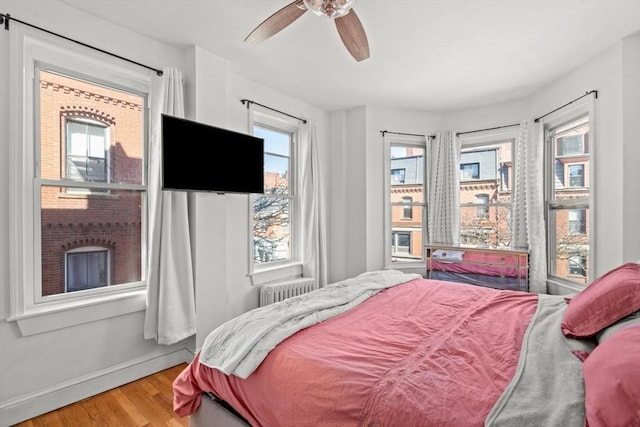 220-224 Washington St Unit 6, Brookline, MA 02445 - bedroom with baseboards, a ceiling fan, radiator, and wood finished floors
