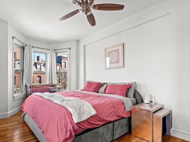 220-224 Washington St Unit 6, Brookline, MA 02445 - bedroom featuring baseboards, a ceiling fan, and wood finished floors