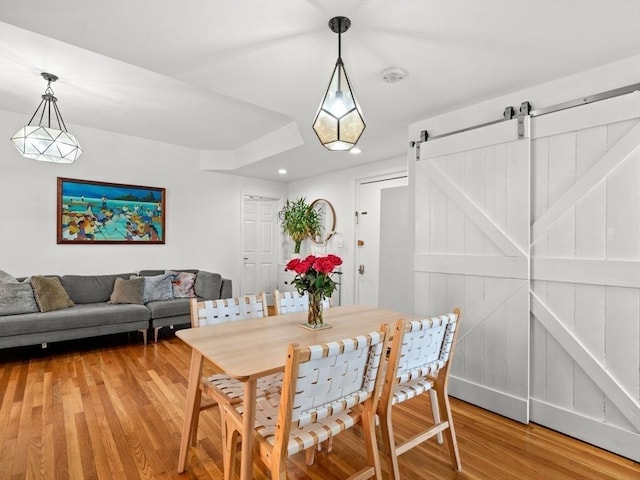 220-224 Washington St Unit 6, Brookline, MA 02445 - dining space featuring light wood-style floors, recessed lighting, and a barn door