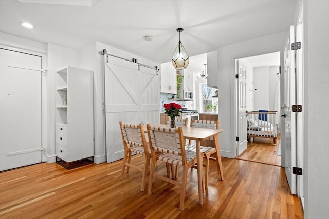 220-224 Washington St Unit 6, Brookline, MA 02445 - dining area with recessed lighting, a barn door, and light wood-type flooring