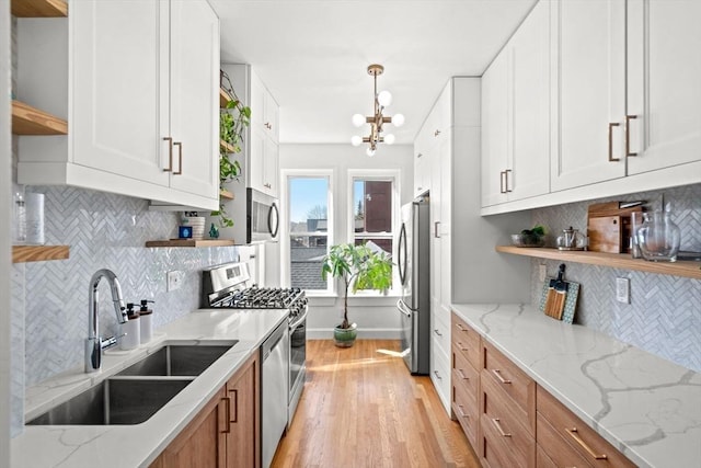 220-224 Washington St Unit 6, Brookline, MA 02445 - kitchen with open shelves, a sink, appliances with stainless steel finishes, and backsplash