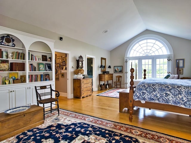 bedroom featuring hardwood / wood-style flooring and lofted ceiling