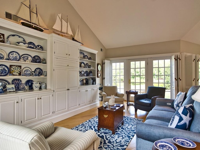 living room featuring light hardwood / wood-style floors and vaulted ceiling