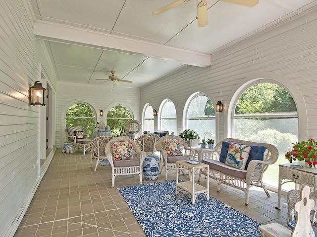 sunroom / solarium with ceiling fan and beam ceiling