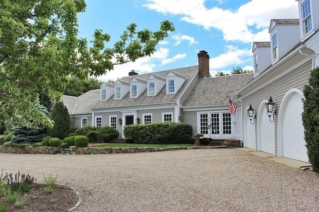 view of front of home with a garage and french doors