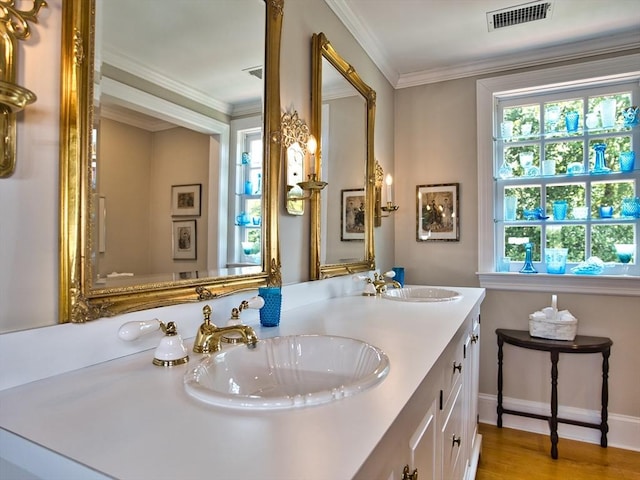 bathroom featuring ornamental molding, hardwood / wood-style flooring, and vanity