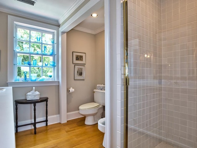 bathroom with a bidet, toilet, a shower with shower door, wood-type flooring, and ornamental molding