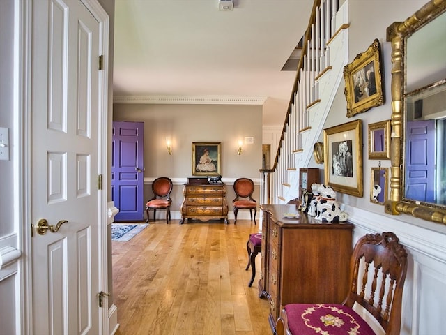 entrance foyer with crown molding and light wood-type flooring