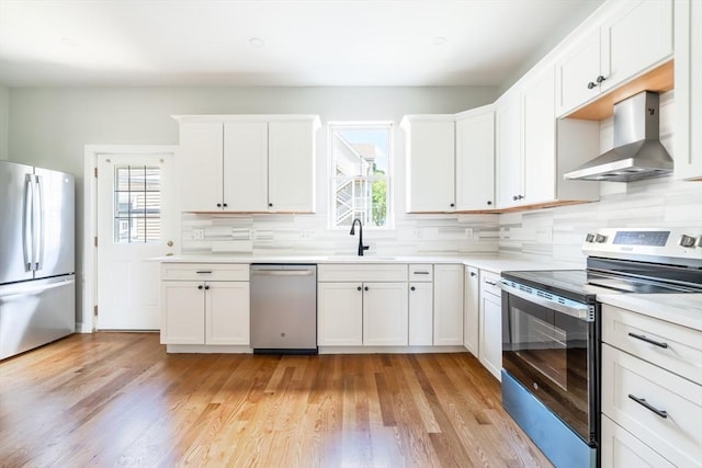 39 Mount Pleasant St, Somerville, MA 02145 - kitchen featuring stainless steel appliances, wall chimney exhaust hood, healthy amount of natural light, and backsplash