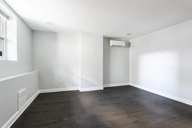 39 Mount Pleasant St, Somerville, MA 02145 - spare room with a wall mounted air conditioner, dark wood-style flooring, and recessed lighting
