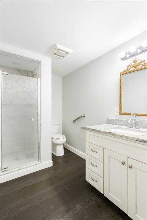 39 Mount Pleasant St, Somerville, MA 02145 - full bathroom featuring vanity, a stall shower, and wood finished floors