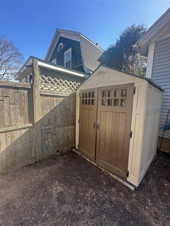 view of shed with fence