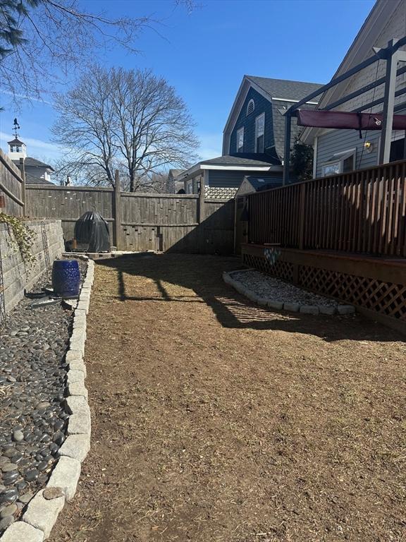 view of yard with a deck and a fenced backyard