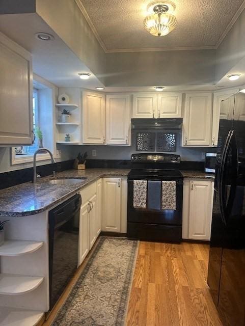 kitchen featuring black appliances, ornamental molding, open shelves, a sink, and light wood-style floors