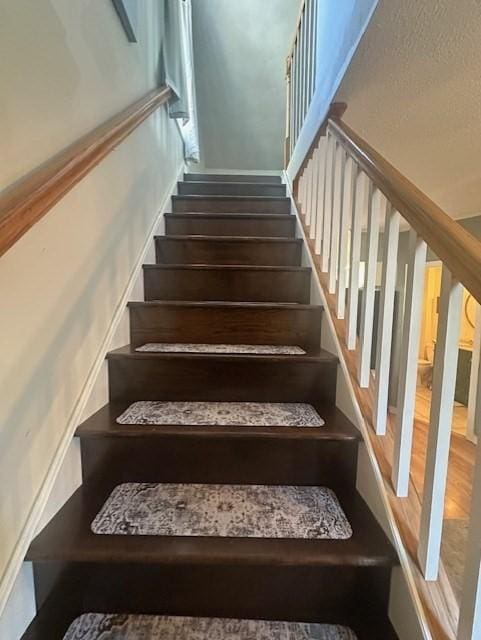 staircase with wood finished floors