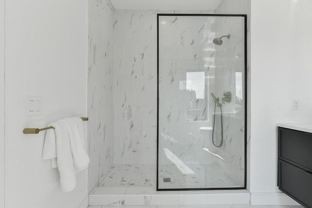 bathroom featuring a tile shower and vanity