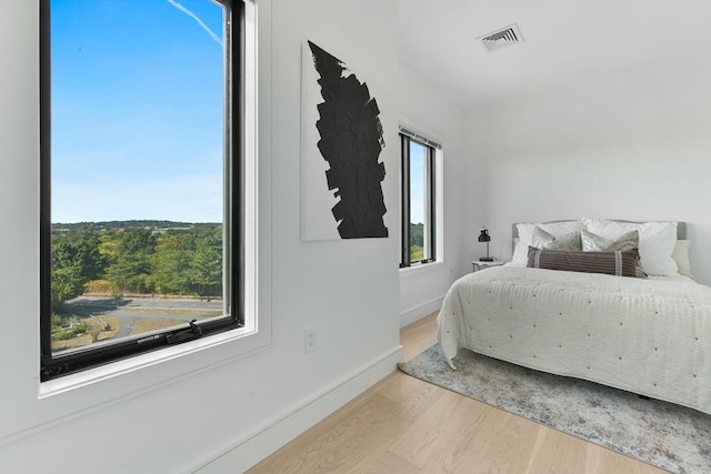 bedroom with hardwood / wood-style flooring