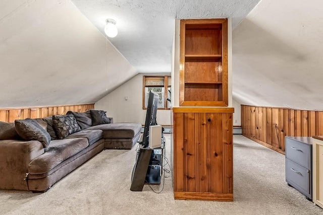 carpeted living area featuring wood walls and vaulted ceiling