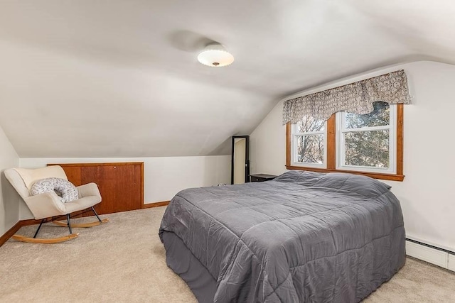 bedroom featuring vaulted ceiling, baseboard heating, baseboards, and light colored carpet