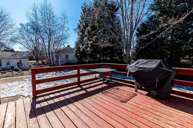 wooden terrace featuring a grill