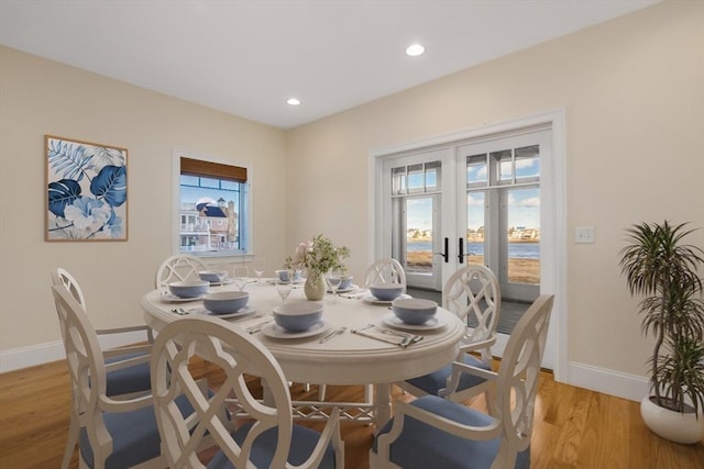 dining room featuring recessed lighting, light wood-style flooring, baseboards, and french doors