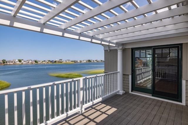 wooden terrace with a water view and a pergola