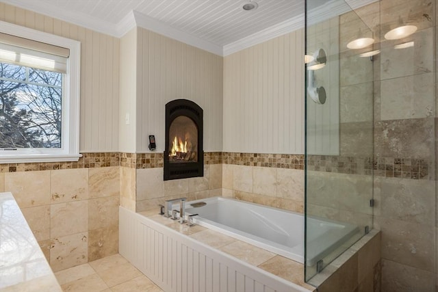 full bathroom with tile patterned flooring, tile walls, ornamental molding, a tile shower, and a bath